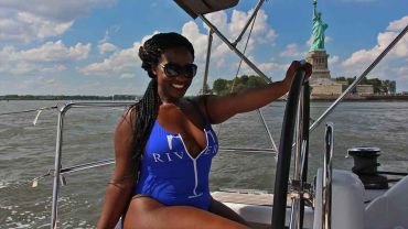 Sailing at the helm near the Statue Of Liberty